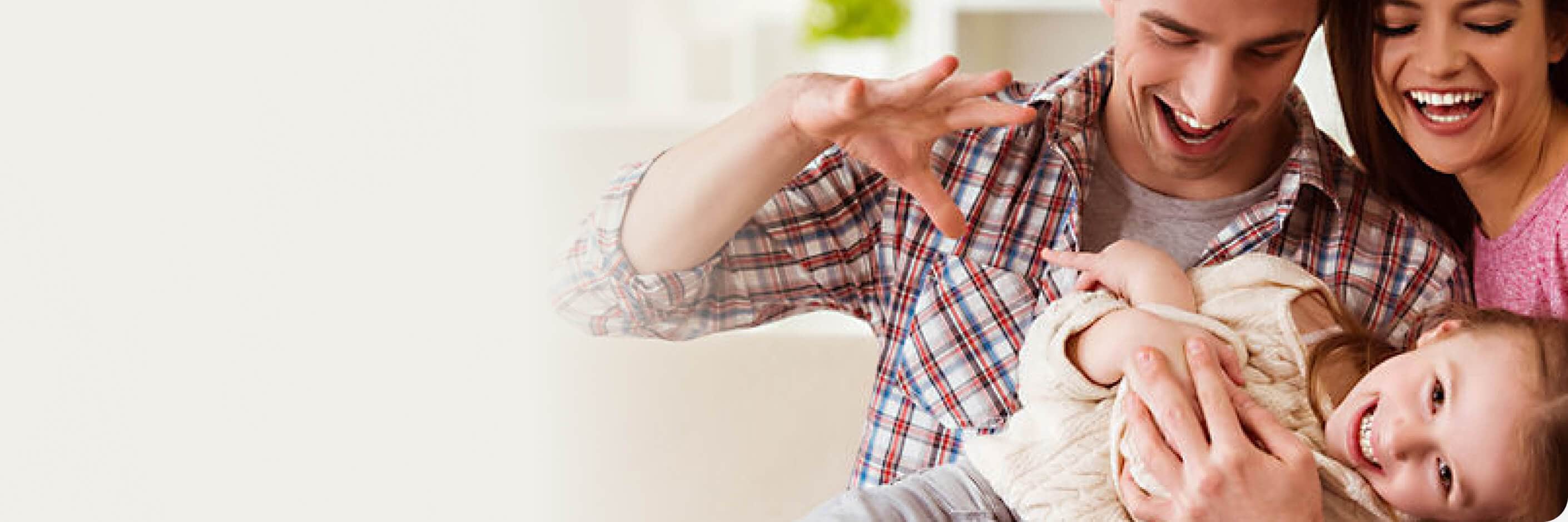 A dental professional wearing safety PPE gear and white lab coat smiling compassionately